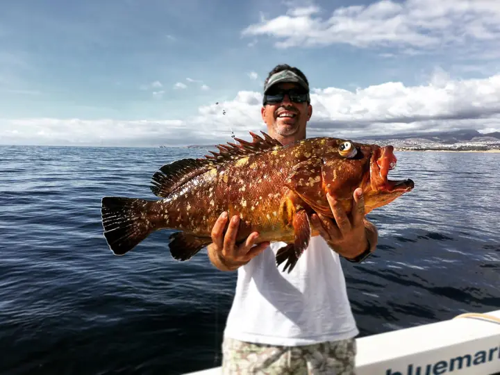 Fiskare med en röd grouper